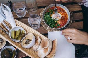 Shakshuka, Fried Eggs in Tomato Sauce on the Table photo