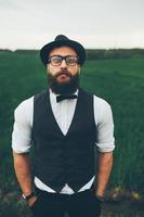 man with a beard, thinking in the field photo