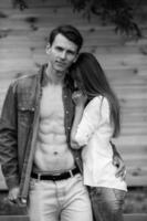 couple posing on a background of the wooden wall photo