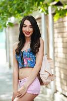 beautiful girl poses for camera in the city photo