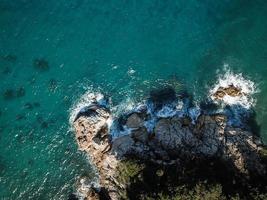 Drone top view of a sea cliff and a beach photo