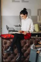 Brunette woman with eyeglasses using tablet photo