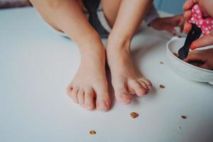 the legs of a small child in the flour photo