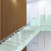 Modern staircase with glass railings in interior photo