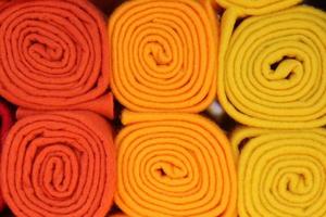 Detailed close up view on samples of cloth and fabrics in different colors found at a fabrics market photo