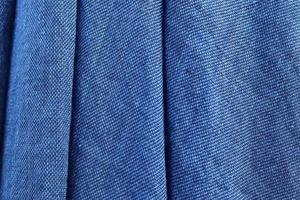 Detailed close up view on samples of cloth and fabrics in different colors found at a fabrics market photo