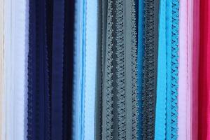 Detailed close up view on samples of cloth and fabrics in different colors found at a fabrics market photo