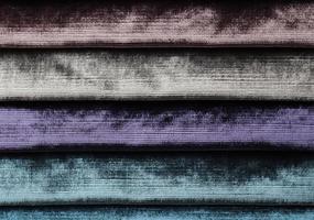 Detailed close up view on samples of cloth and fabrics in different colors found at a fabrics market photo
