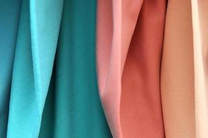 Detailed close up view on samples of cloth and fabrics in different colors found at a fabrics market photo