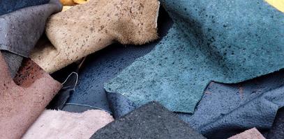 Detailed close up view on samples of cloth and fabrics in different colors found at a fabrics market photo