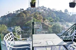 Early morning view of Modern rooftop restaurant at Kasauli, Himachal Pradesh in India, View of mountain hills from open air restaurant in Kasauli, Kasauli Rooftop restaurant photo