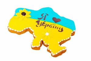 Gingerbread in the form of a map of Ukraine in yellow and blue colors with drawn hearts. Ukrainian. photo