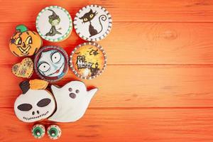 Delicious gingerbread cookies on a brown wooden background, Halloween theme. Halloween treats. photo