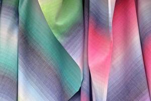 Detailed close up view on samples of cloth and fabrics in different colors found at a fabrics market photo