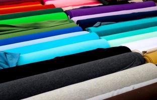 Detailed close up view on samples of cloth and fabrics in different colors found at a fabrics market photo