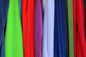 Detailed close up view on samples of cloth and fabrics in different colors found at a fabrics market photo