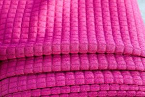 Detailed close up view on samples of cloth and fabrics in different colors found at a fabrics market photo