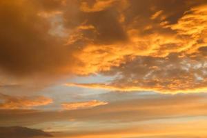 Beautiful orange and yellow clouds at sunrise and sunset in the sky. photo