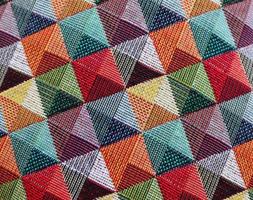 Detailed close up view on samples of cloth and fabrics in different colors found at a fabrics market photo