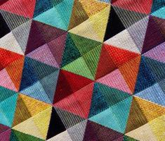 Detailed close up view on samples of cloth and fabrics in different colors found at a fabrics market photo