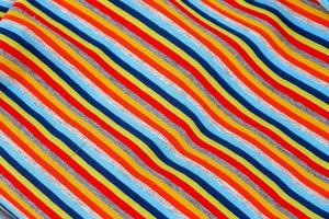 Detailed close up view on samples of cloth and fabrics in different colors found at a fabrics market photo