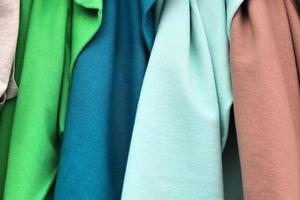 Detailed close up view on samples of cloth and fabrics in different colors found at a fabrics market photo