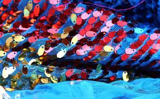 Detailed close up view on samples of cloth and fabrics in different colors found at a fabrics market photo