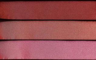 Detailed close up view on samples of cloth and fabrics in different colors found at a fabrics market photo