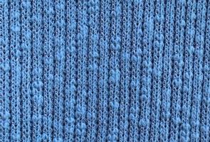 Detailed close up view on samples of cloth and fabrics in different colors found at a fabrics market photo