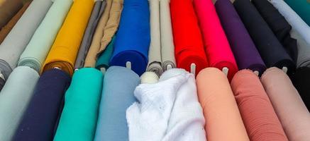 Detailed close up view on samples of cloth and fabrics in different colors found at a fabrics market photo