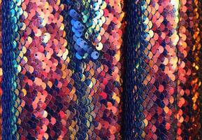 Detailed close up view on samples of cloth and fabrics in different colors found at a fabrics market photo