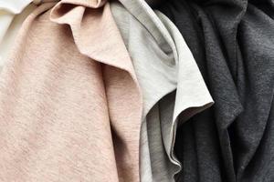 Detailed close up view on samples of cloth and fabrics in different colors found at a fabrics market photo