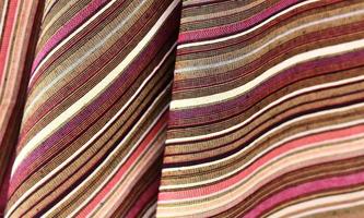 Detailed close up view on samples of cloth and fabrics in different colors found at a fabrics market photo