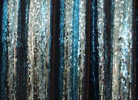 Detailed close up view on samples of cloth and fabrics in different colors found at a fabrics market photo