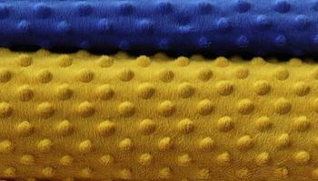 Detailed close up view on samples of cloth and fabrics in different colors found at a fabrics market photo