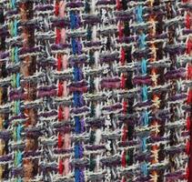 Detailed close up view on samples of cloth and fabrics in different colors found at a fabrics market photo
