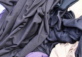 Detailed close up view on samples of cloth and fabrics in different colors found at a fabrics market photo