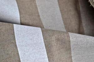 Detailed close up view on samples of cloth and fabrics in different colors found at a fabrics market photo