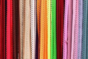 Detailed close up view on samples of cloth and fabrics in different colors found at a fabrics market photo