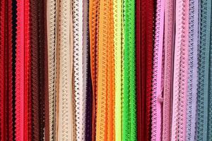 Detailed close up view on samples of cloth and fabrics in different colors found at a fabrics market photo