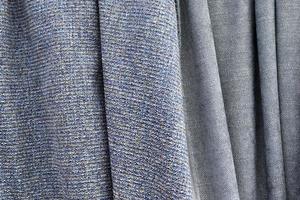 Detailed close up view on samples of cloth and fabrics in different colors found at a fabrics market photo