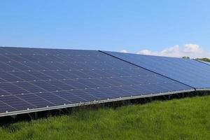 Generating clean energy with solar modules in a big park in northern Europe photo