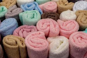Detailed close up view on samples of cloth and fabrics in different colors found at a fabrics market photo