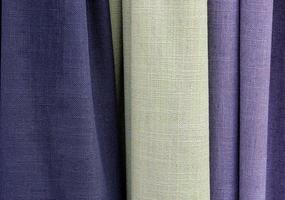 Detailed close up view on samples of cloth and fabrics in different colors found at a fabrics market photo