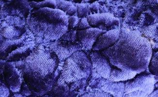 Detailed close up view on samples of cloth and fabrics in different colors found at a fabrics market photo