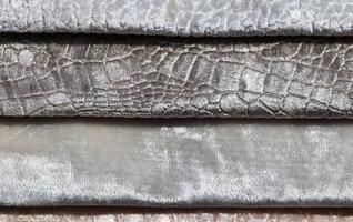 Detailed close up view on samples of cloth and fabrics in different colors found at a fabrics market photo