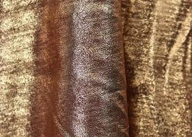 Detailed close up view on samples of cloth and fabrics in different colors found at a fabrics market photo