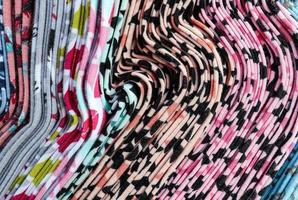 Detailed close up view on samples of cloth and fabrics in different colors found at a fabrics market photo