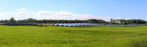 Generating clean energy with solar modules in a big park in northern Europe photo