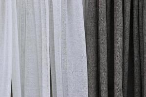 Detailed close up view on samples of cloth and fabrics in different colors found at a fabrics market photo